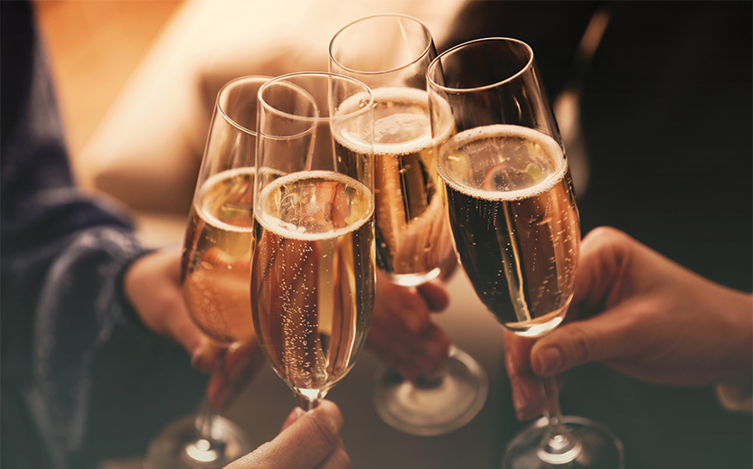 a group of people holding champagne glasses
