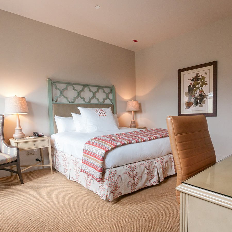 a room with a bed and chair