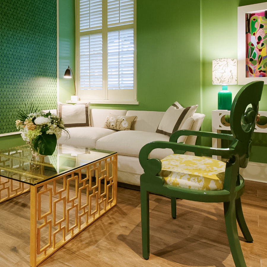 a green living room with a white couch and a gold coffee table