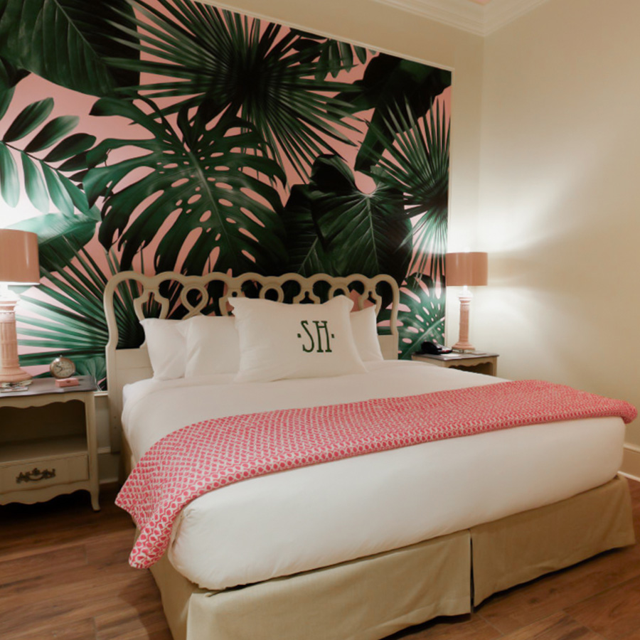 a bed with a pink and white blanket and a pink and white blanket