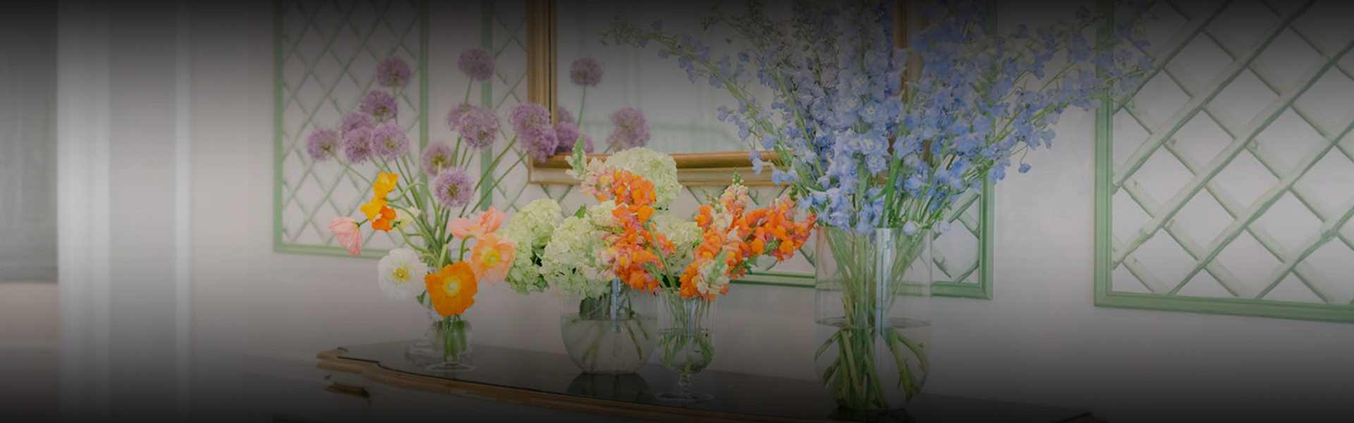 a group of flowers in vases