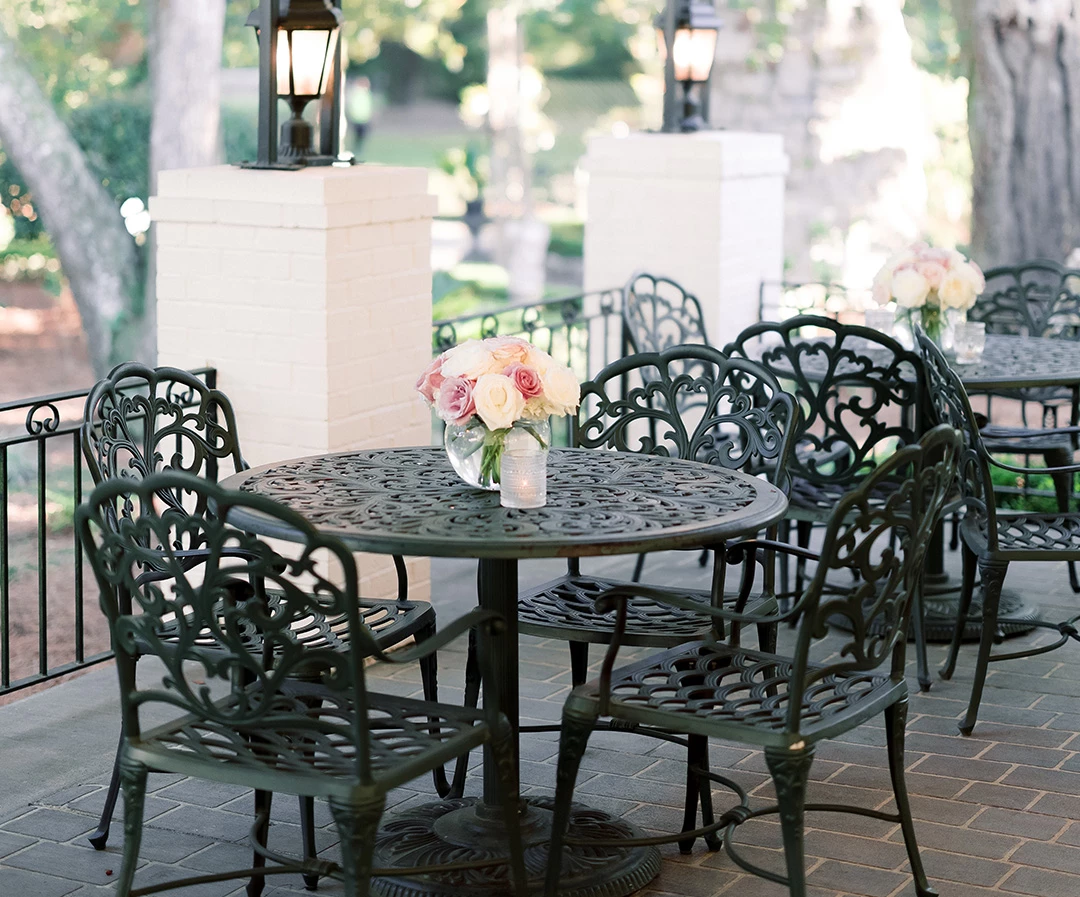 a table and chairs on a brick patio