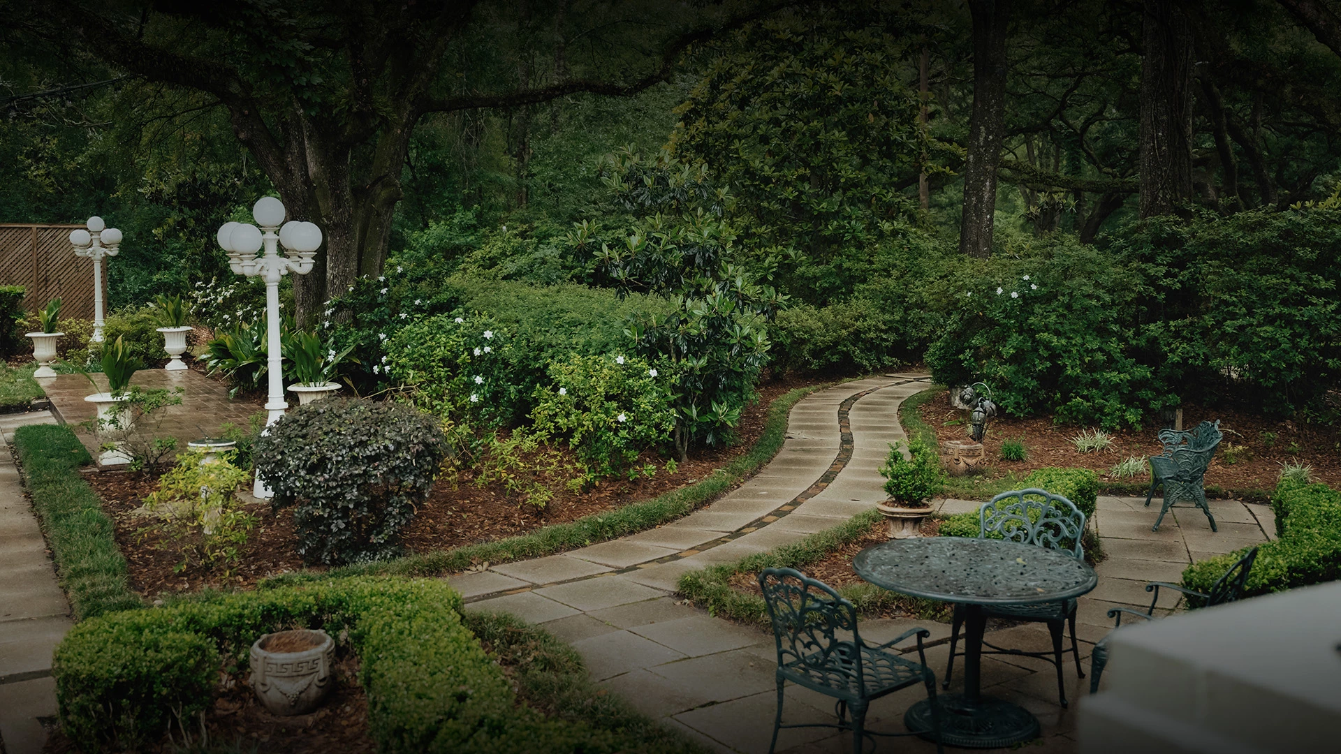 a garden with a table and chairs