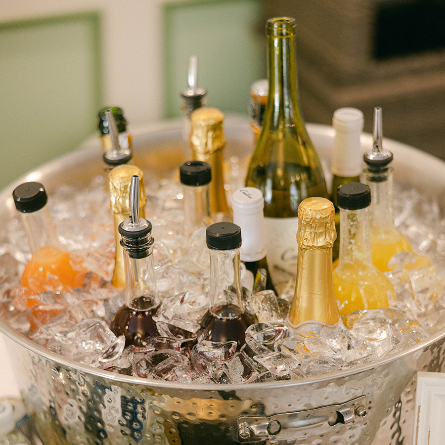 a bucket of ice with bottles of liquid