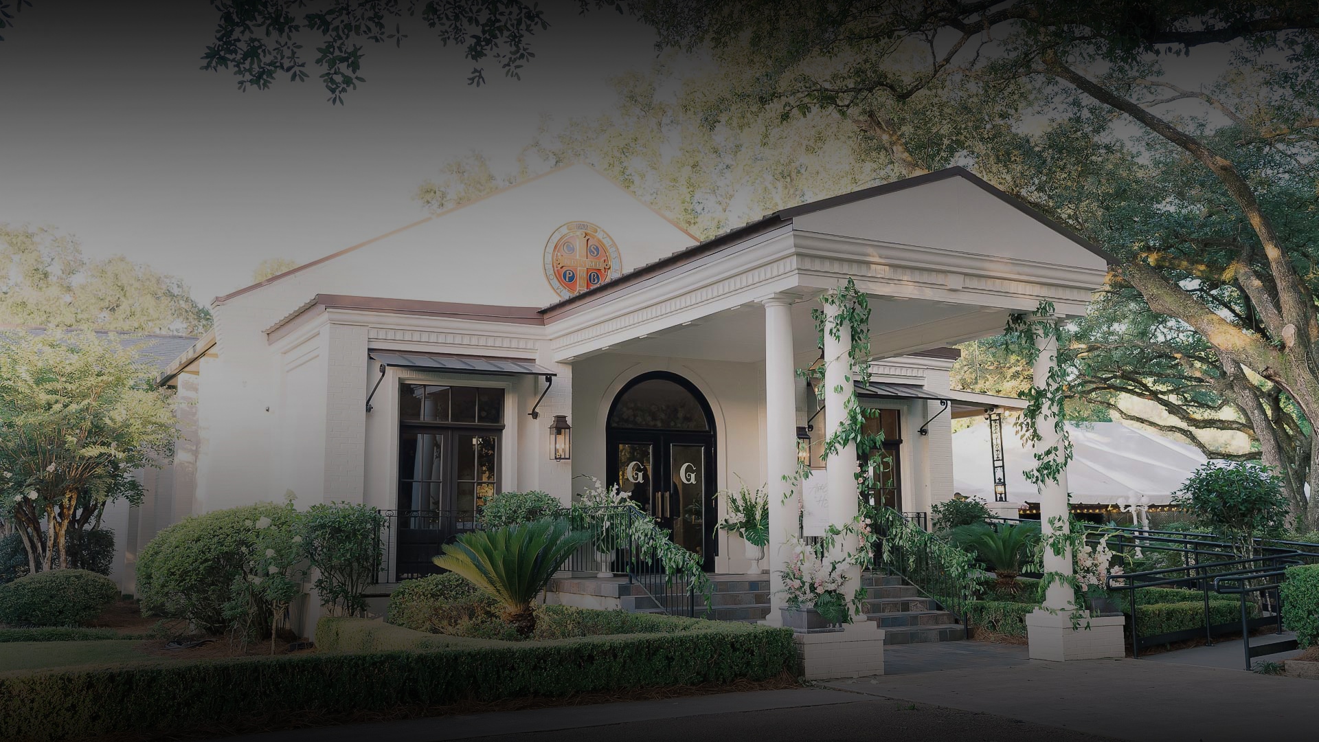 a white house with columns and a large front door