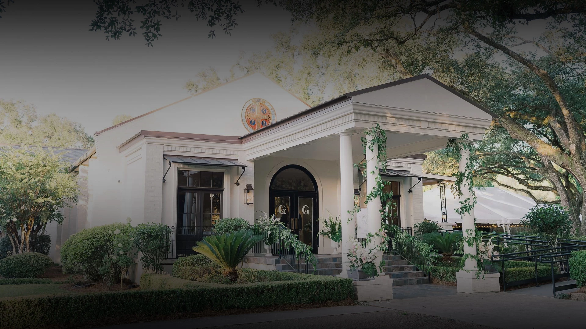 a white house with columns and a large front door