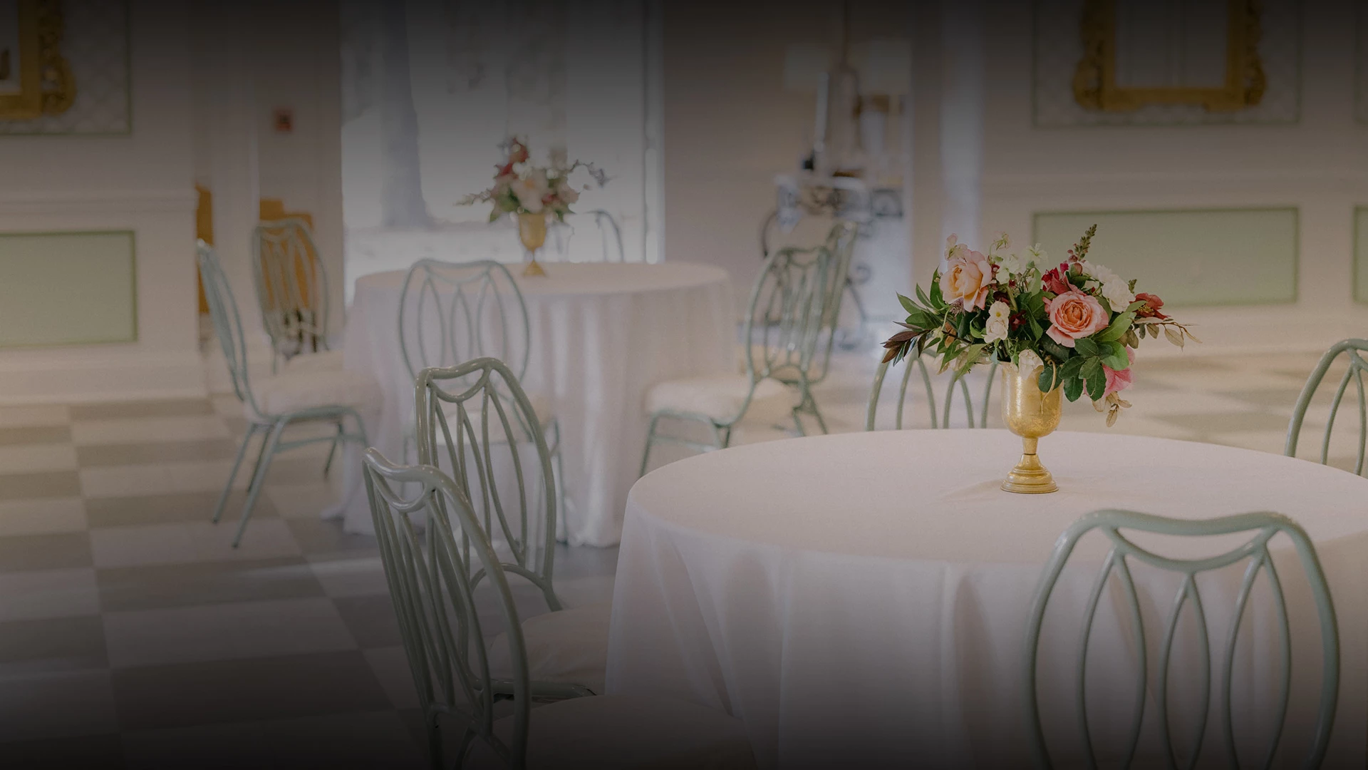 a table with white tablecloths and flowers