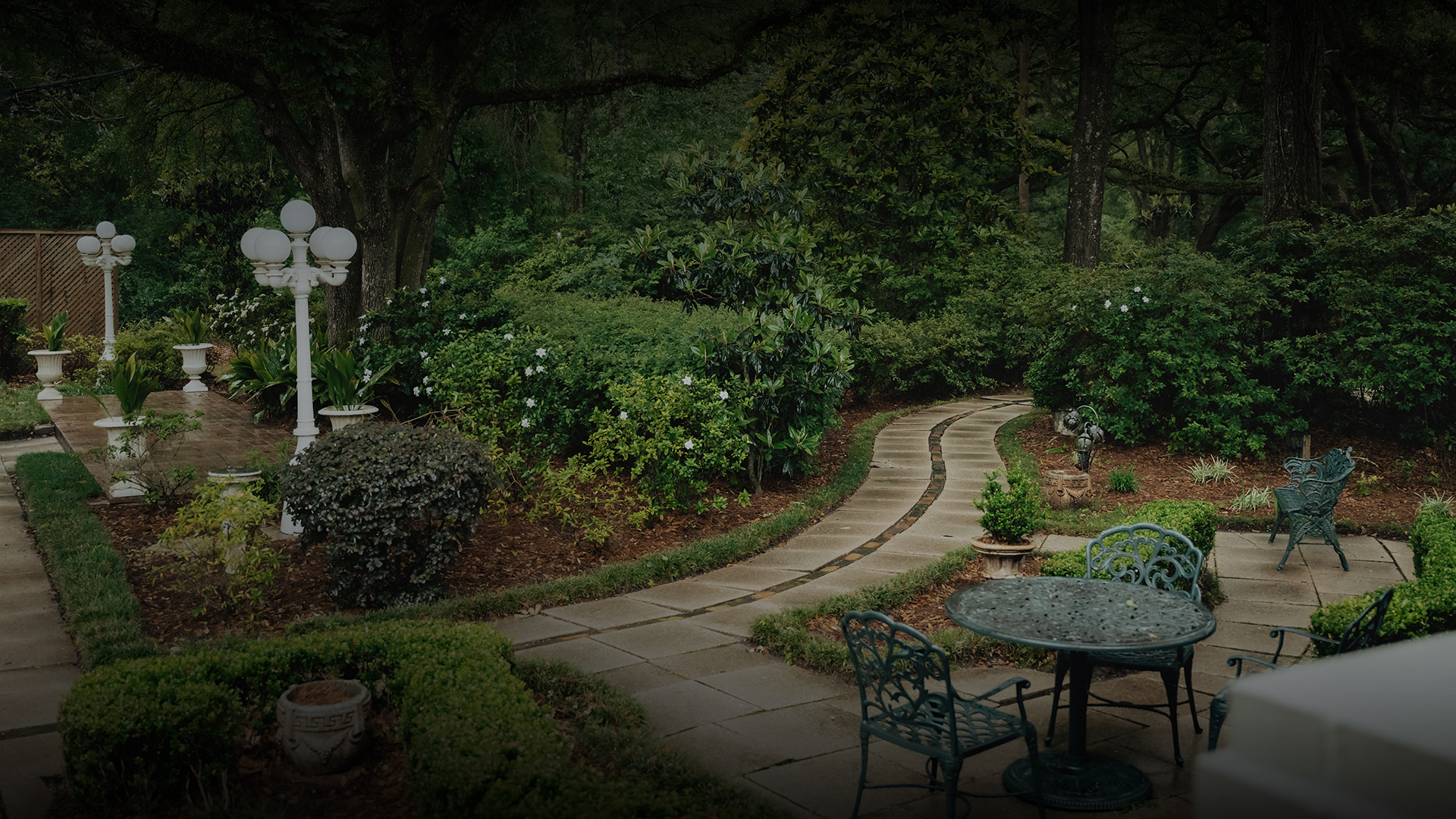 a garden with a table and chairs