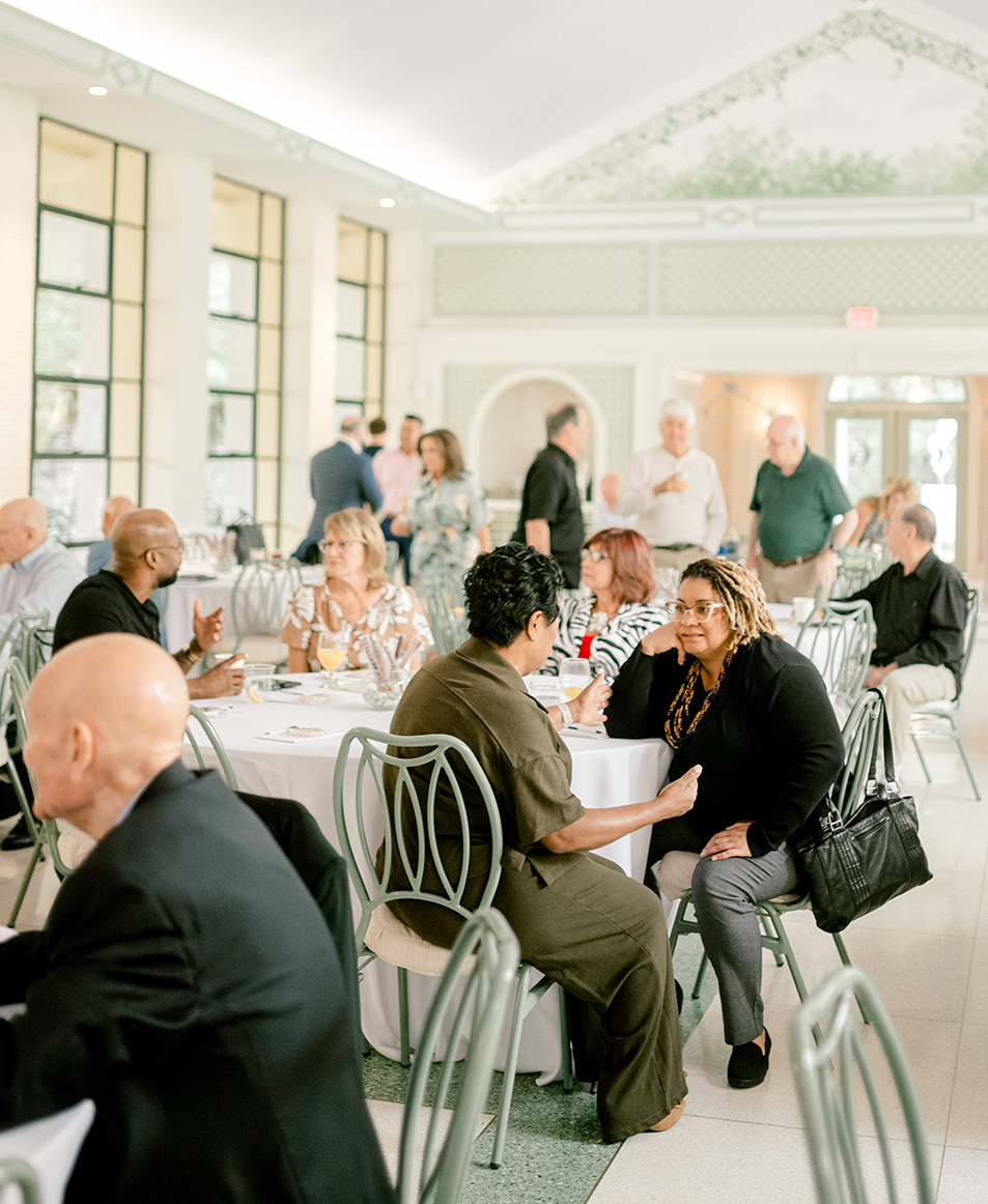 a group of people sitting at tables in a room