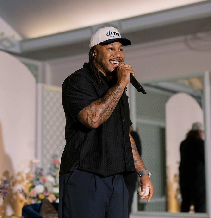 a man with tattoos holding a microphone