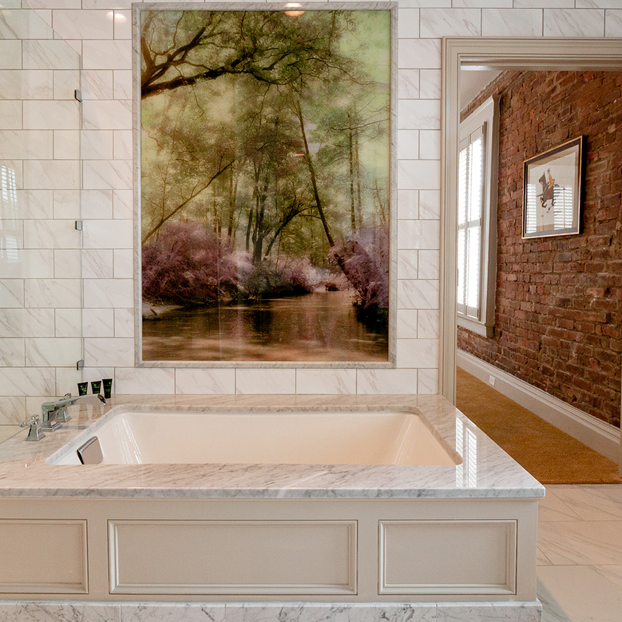 a large white bathtub in a bathroom