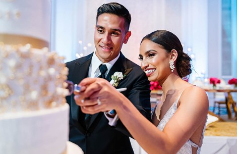 a man and woman cutting a cake