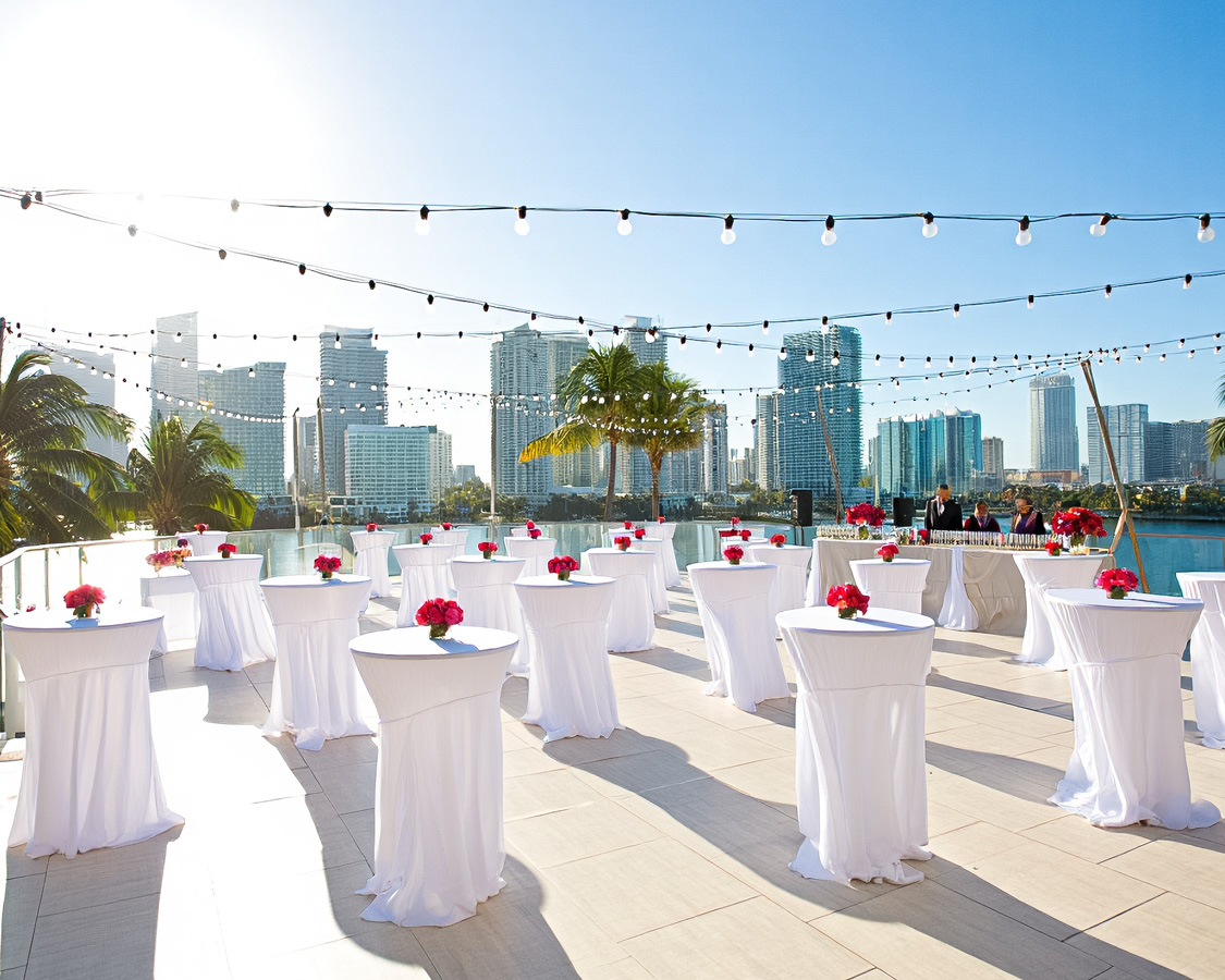 a group of tables with white tables and white tables with flowers