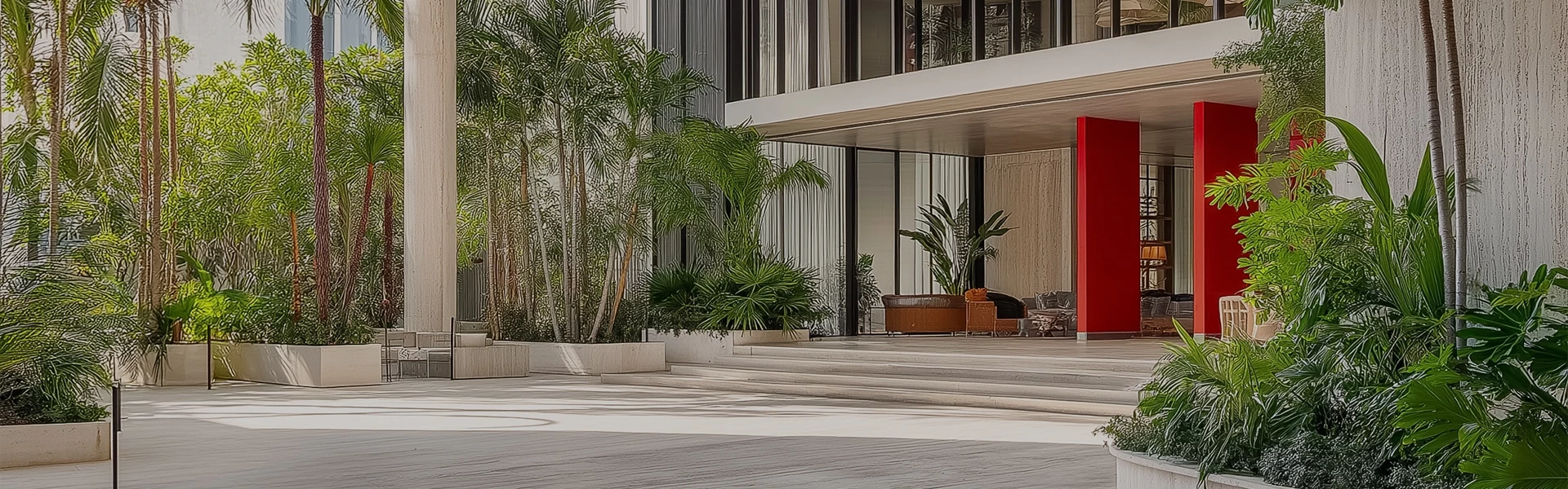 a building with a large staircase and a couch and palm trees