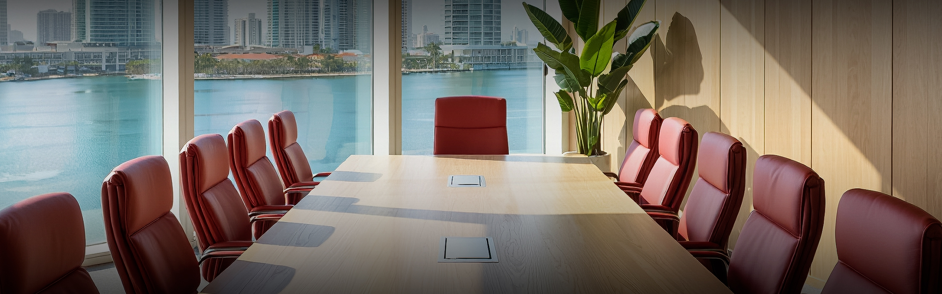 a table with a red chair and a plant in front of a window