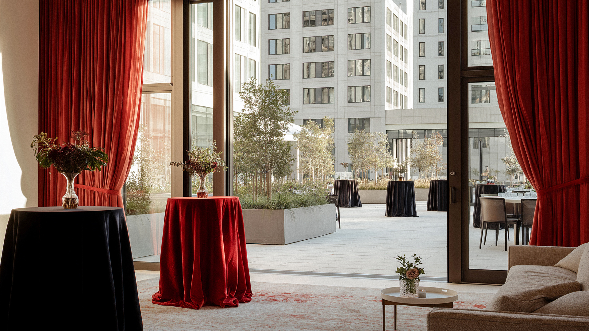 a table with a red cloth and a vase of flowers on it