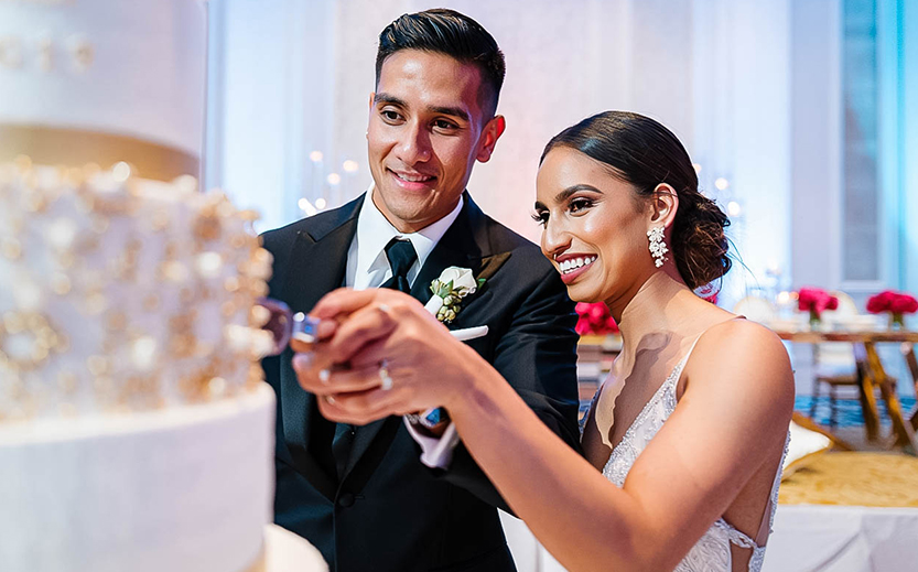 a man and woman cutting a cake