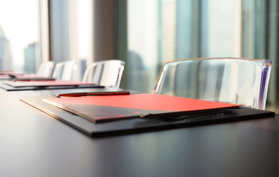 a table with chairs and a red paper on it