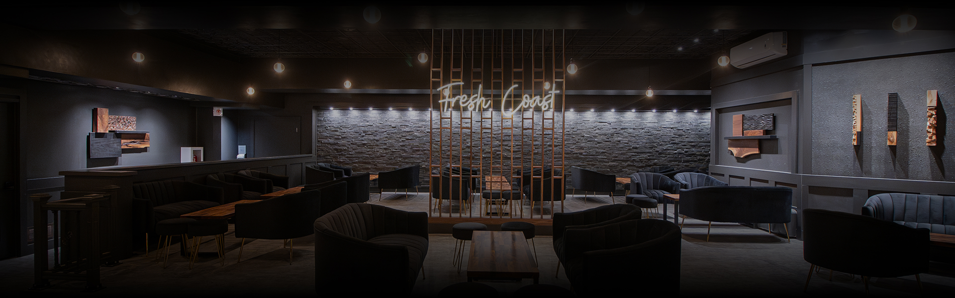 a room with a brick wall and chairs