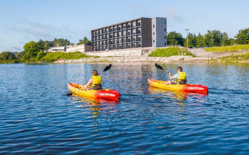 two people in kayaks on a lake