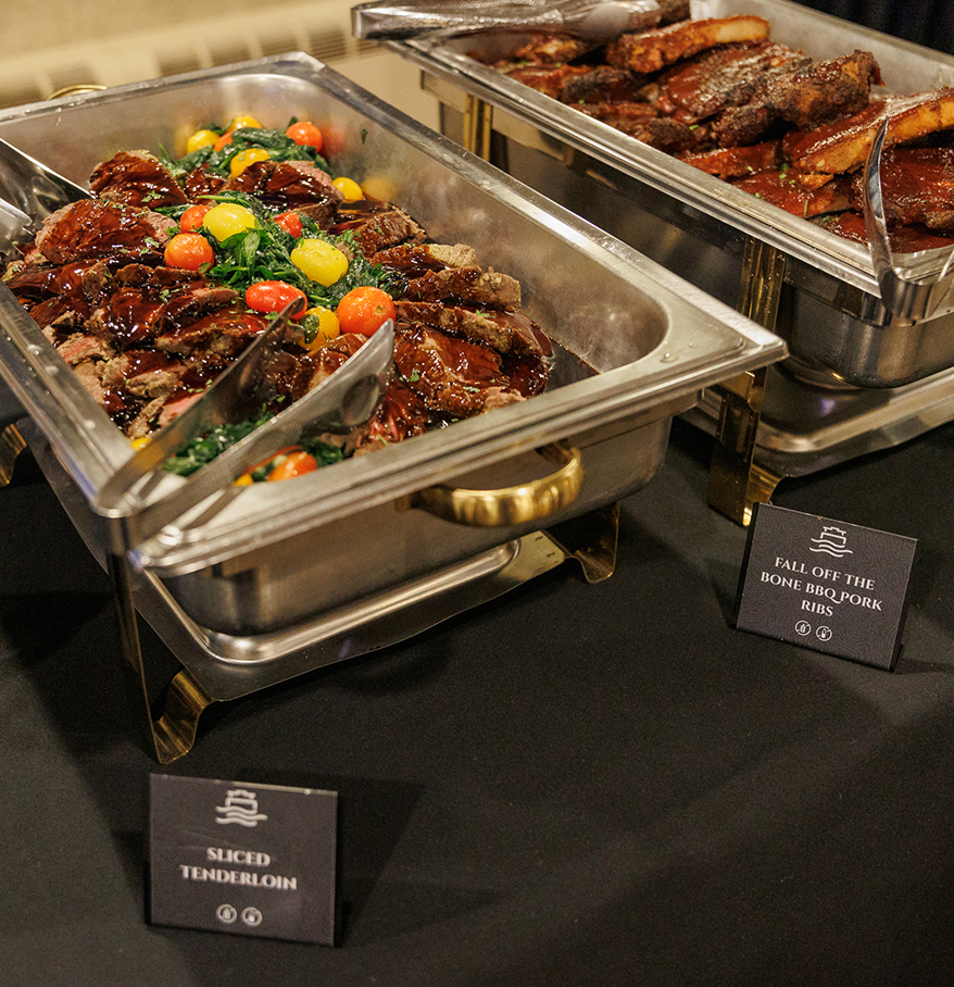 food in a buffet with a sign