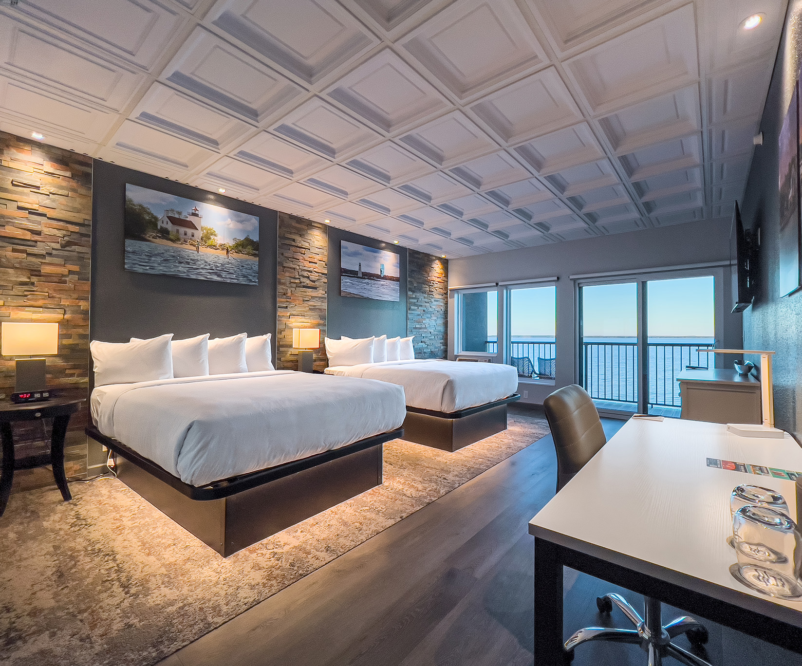 a room with two beds and a desk