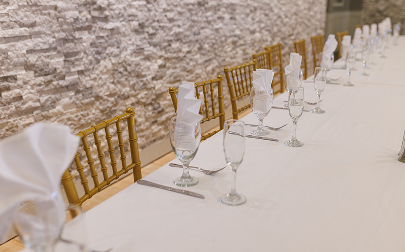 a long table with wine glasses and napkins