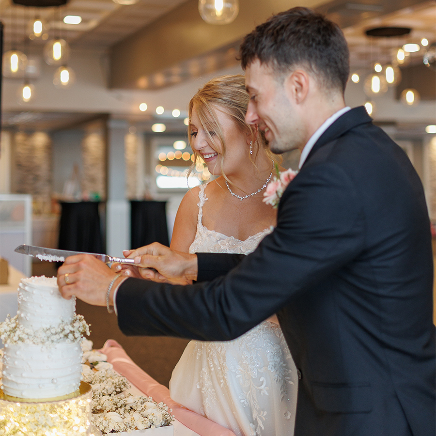 a man and woman cutting a cake
