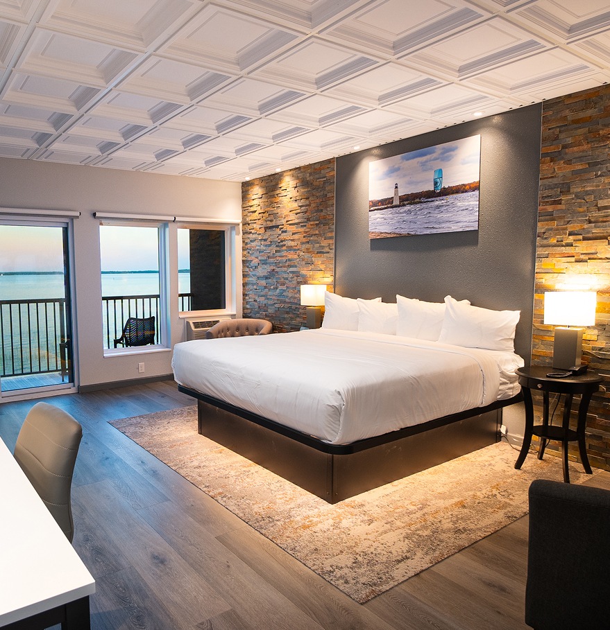 a room with a bed and a table and chairs