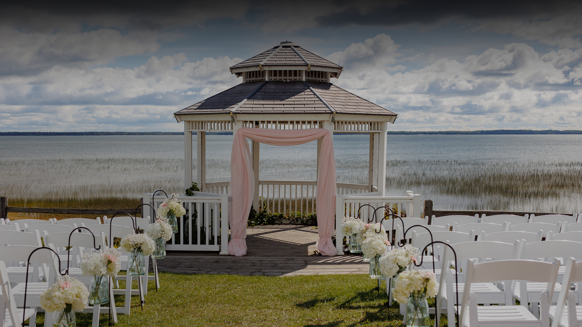 a gazebo with chairs and flowers