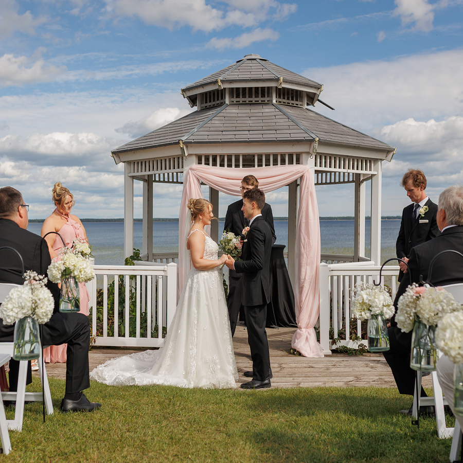 a group of people standing in front of a gazebo