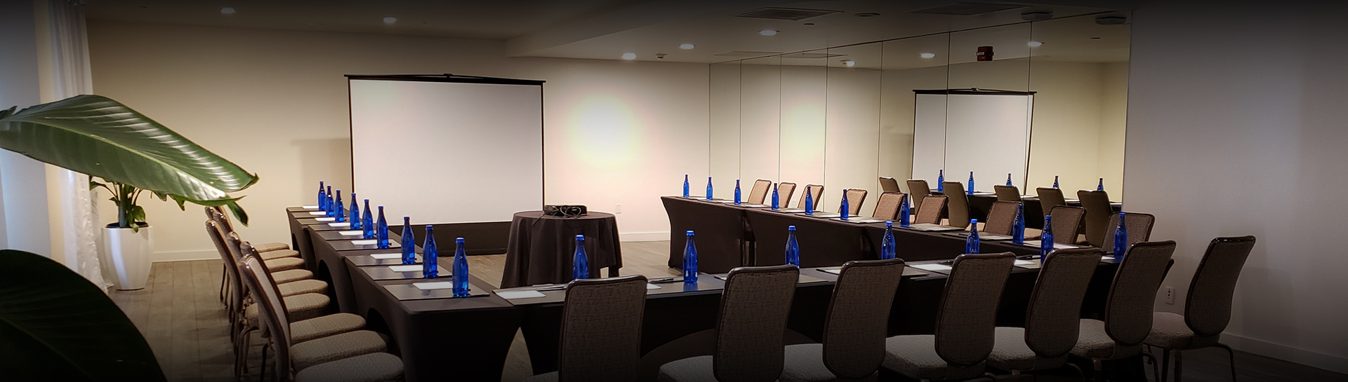 a room with chairs and a projector screen