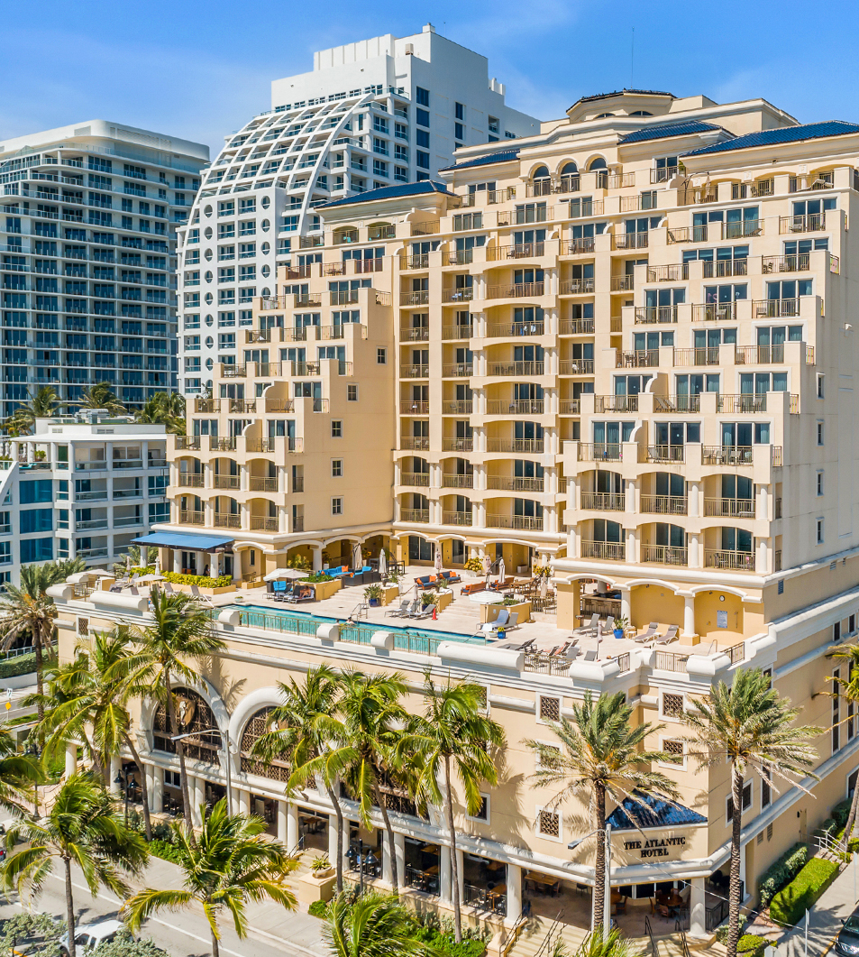a large building with palm trees