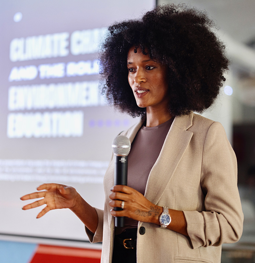 a woman with curly hair holding a microphone