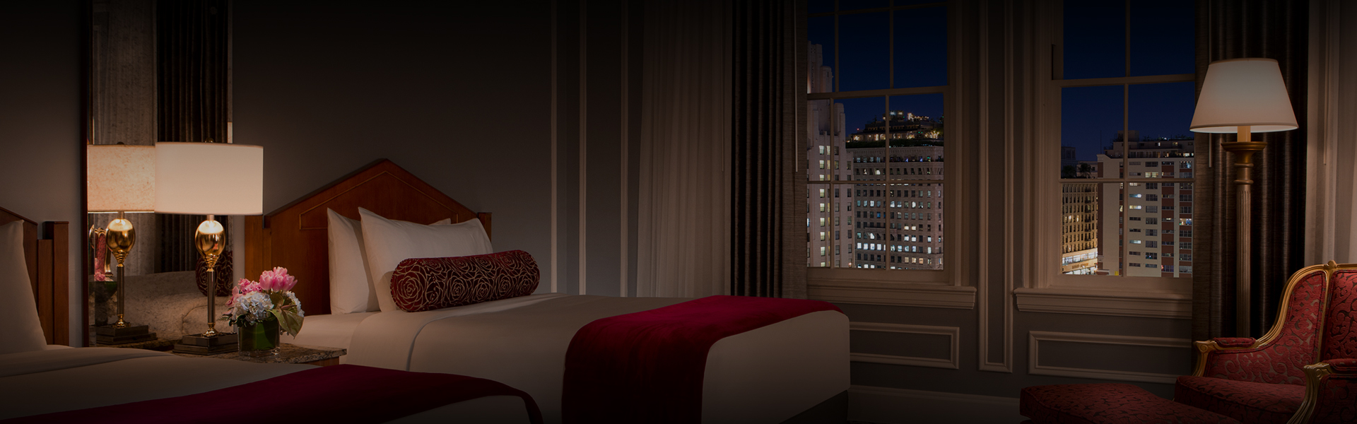 a bed in a room with a window and city view