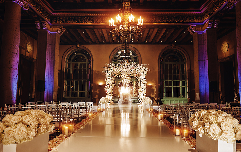 a wedding aisle with candles and flowers