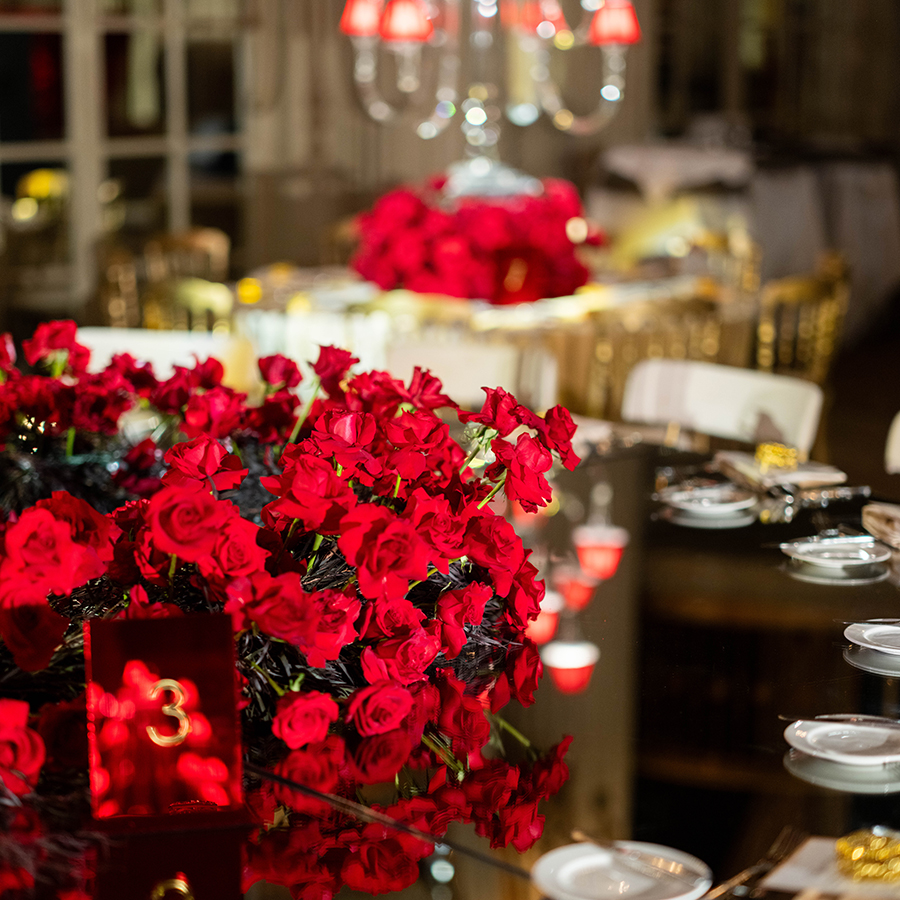 a table with red roses and plates