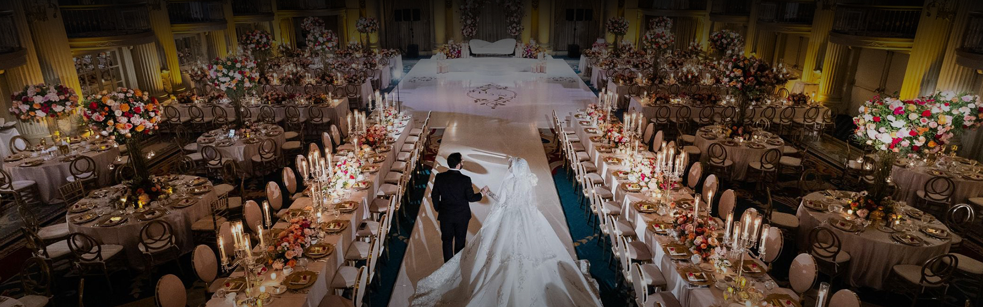 a man and woman in a wedding dress walking down a aisle