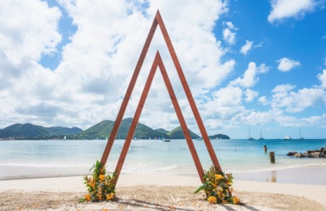 a wooden triangle shaped structure on a beach
