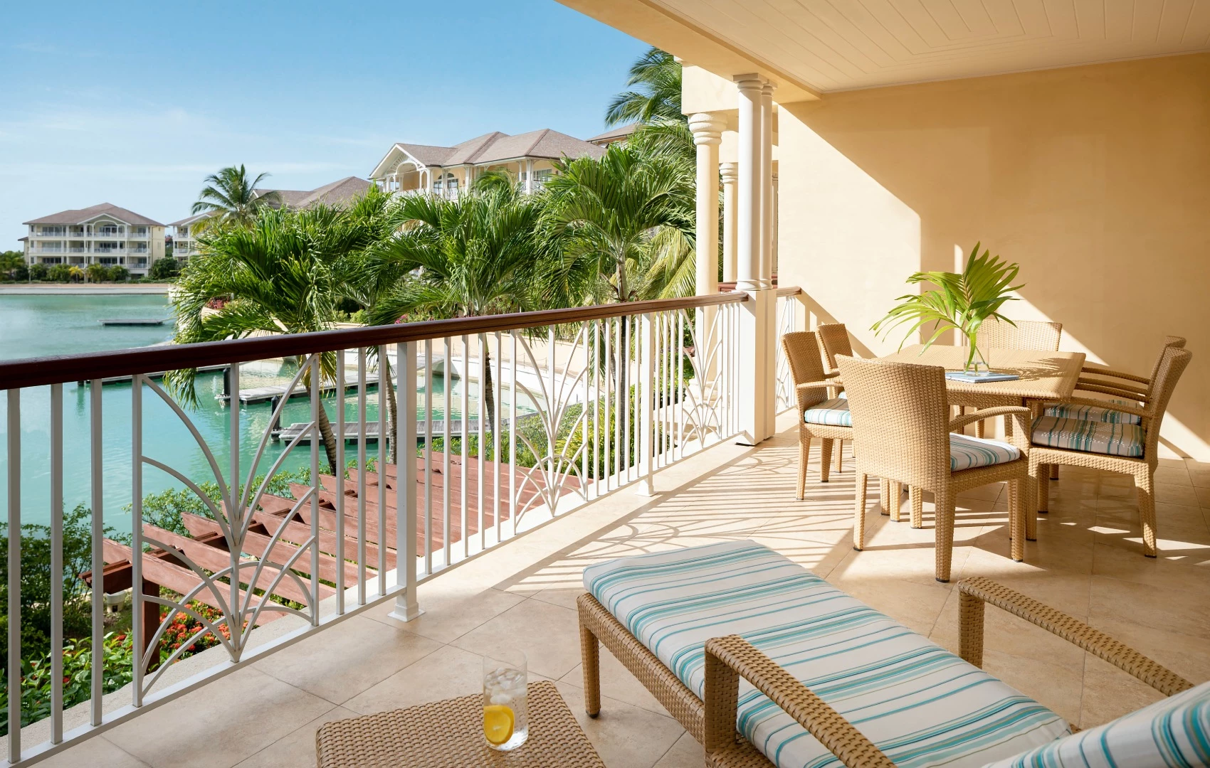 a patio with chairs and a table and chairs on a balcony