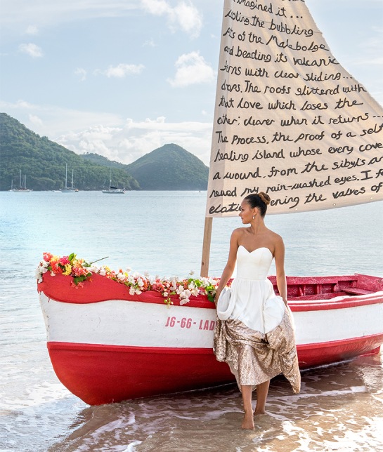 a woman in a dress standing next to a boat