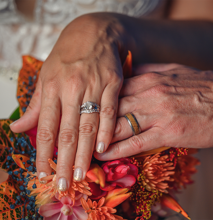 hands holding each other with wedding rings