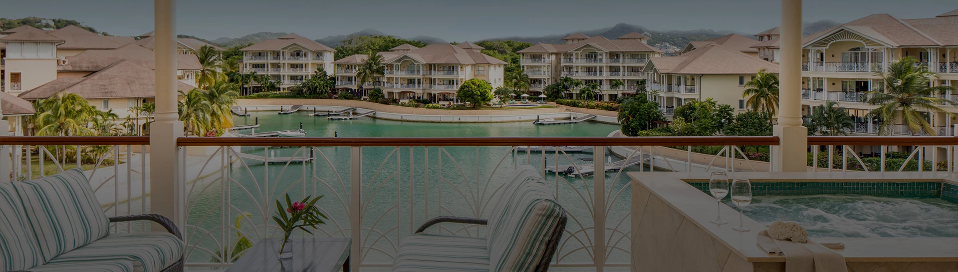 a balcony overlooking a body of water with buildings and trees