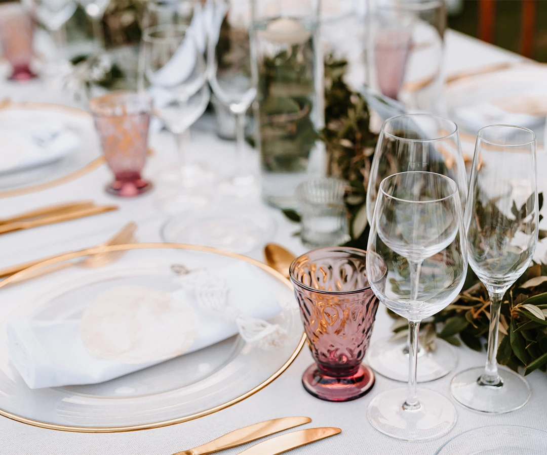 a table with glasses and plates