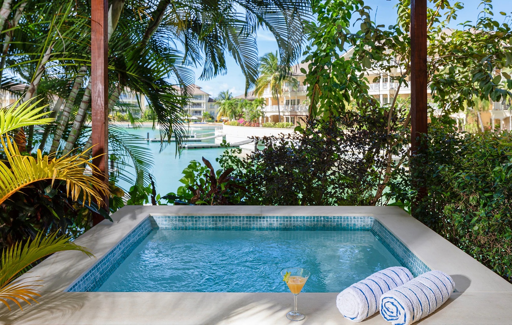 a pool with a drink and towels on it