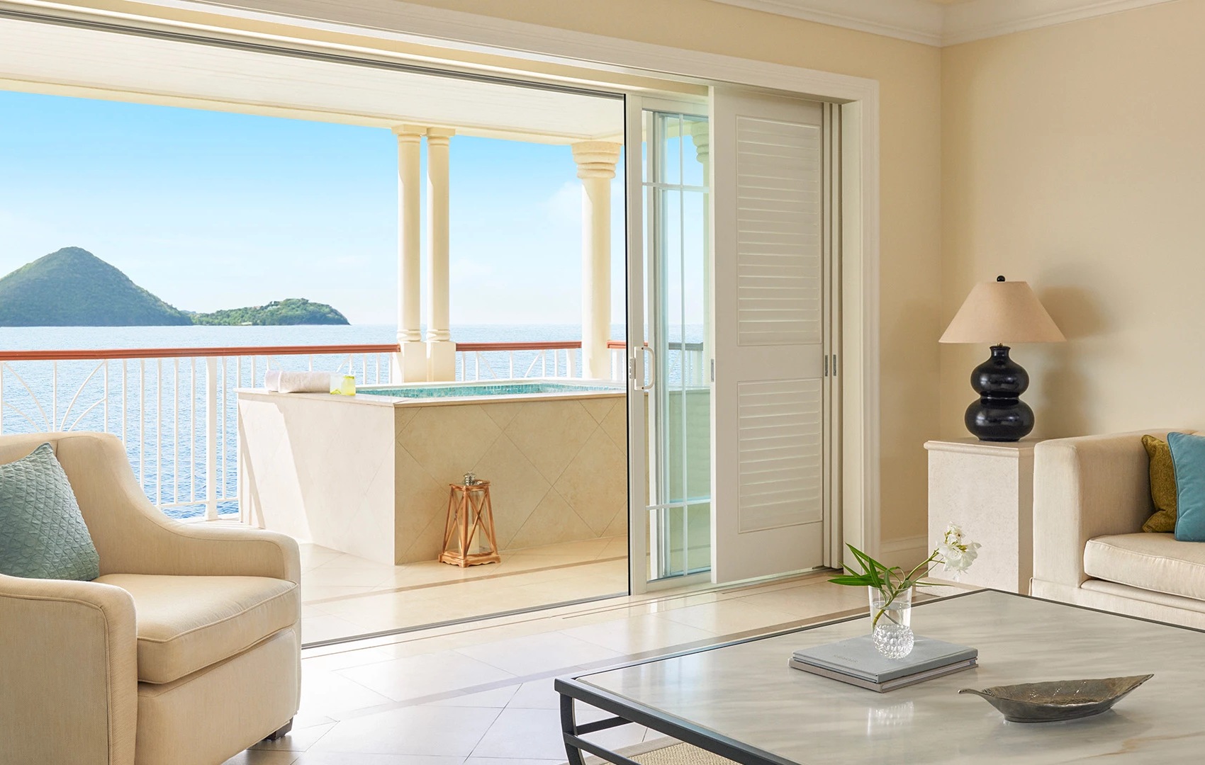 a living room with a view of the ocean
