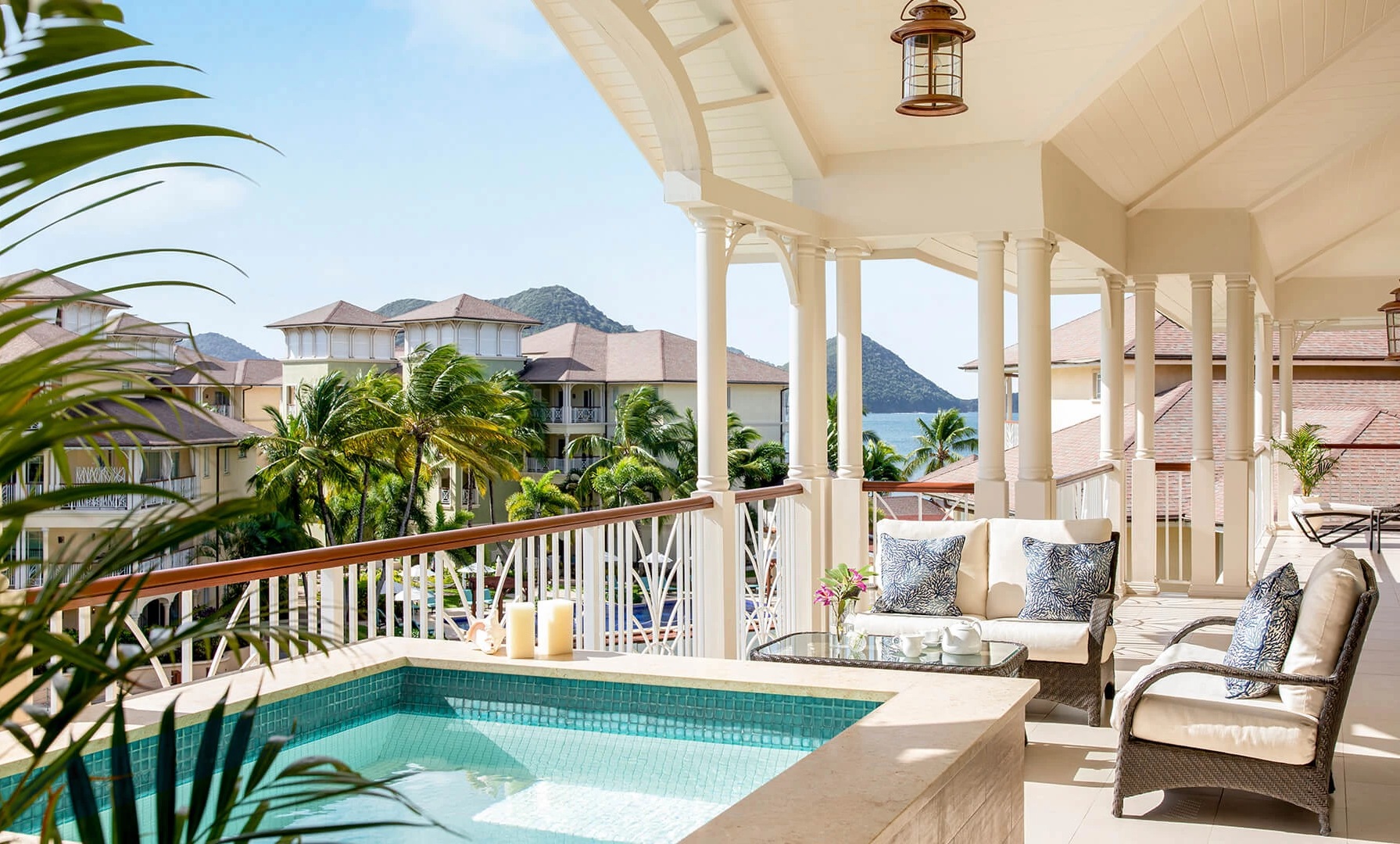 a patio with a hot tub and a sofa
