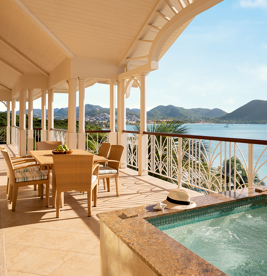 a patio with a hot tub and a table and chairs