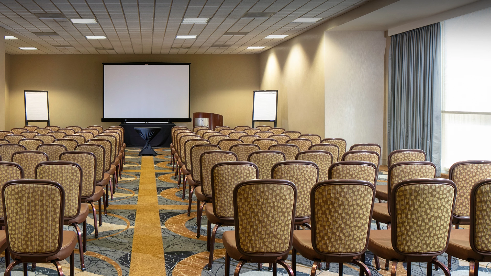 a room with chairs and a projector screen