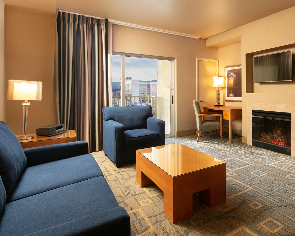 a living room with a fireplace and couches